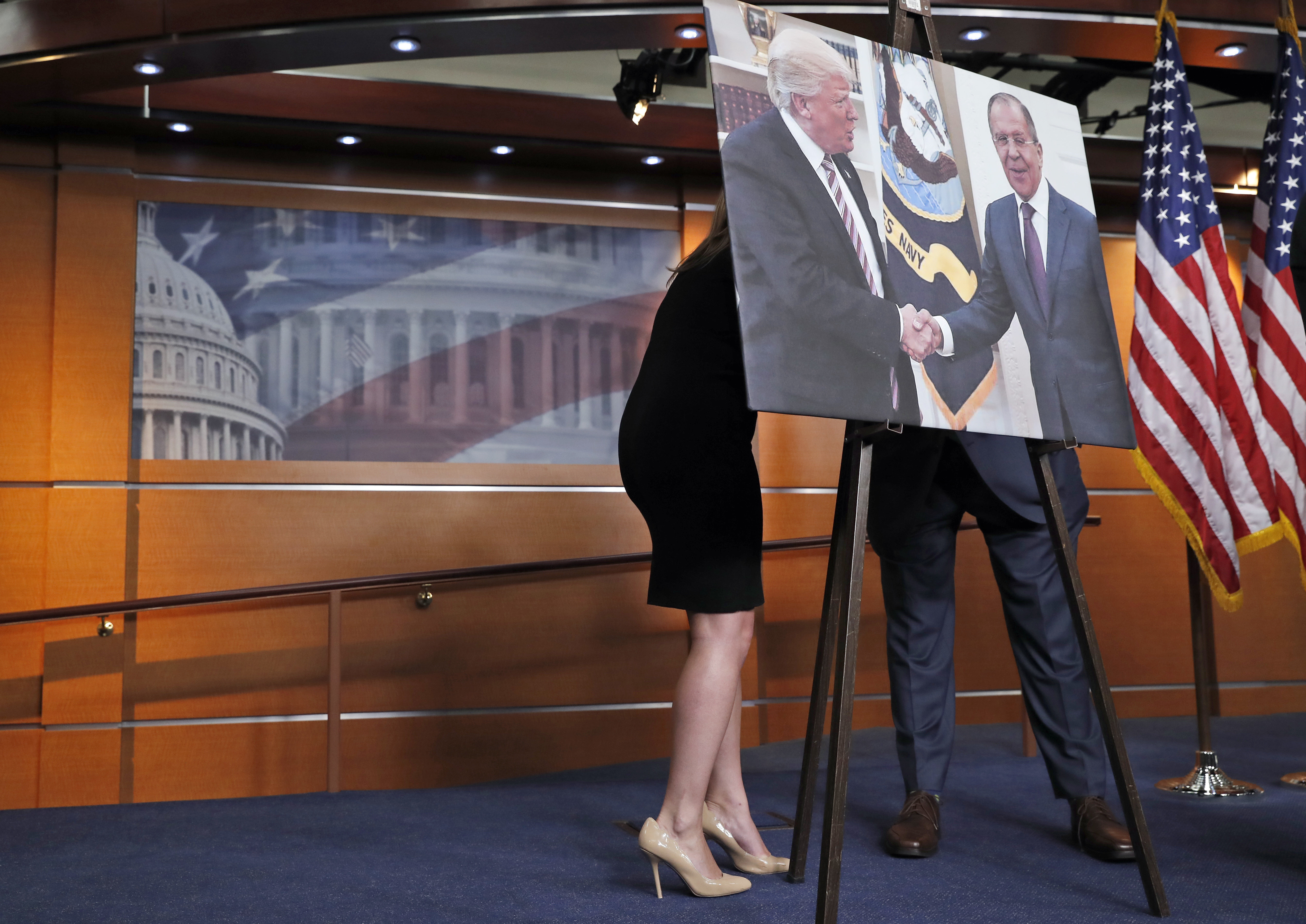 An aide, left, speaks with Rep. Joe Crowley, D-N.Y., chairman of the House Democratic Caucus, and House Oversight and Government Reform Committee ranking member, on Capitol Hill in Washington, Wednesday, May 17, 2017, behind a photograph of President Donald Trump and Russian Foreign Minister Sergey Lavrov, during a news conference An aide, left, speaks with Rep. Joe Crowley, D-N.Y., chairman of the House Democratic Caucus, and House Oversight and Government Reform Committee ranking member, on Capitol Hill in Washington, Wednesday, May 17, 2017, behind a photograph of President Donald Trump and Russian Foreign Minister Sergey Lavrov, during a news conference
