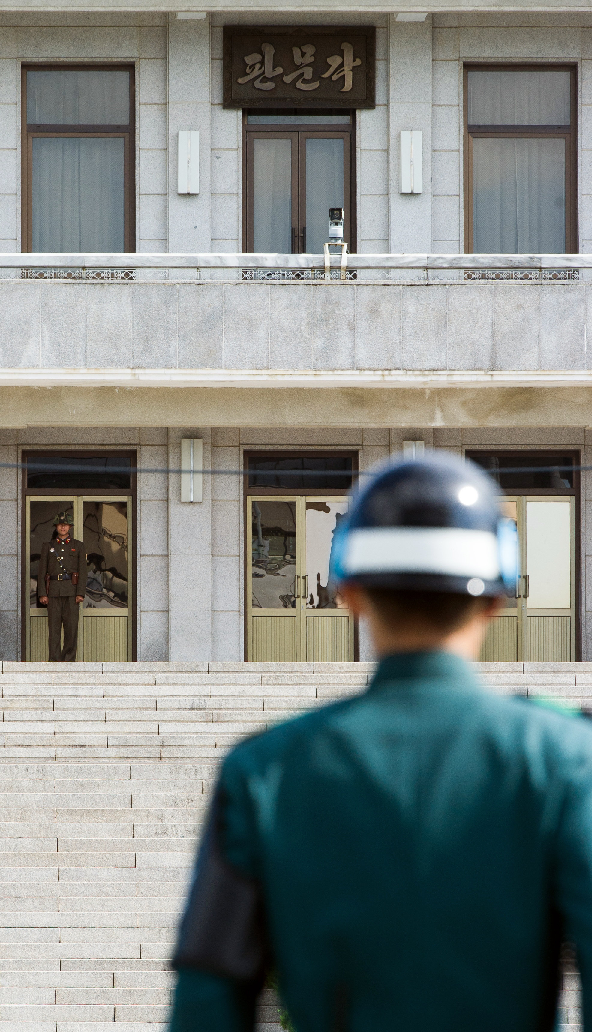 A South Korean JSA guard (front R) and North Korean guard (L) stand guard opposite each other at the border of the truce village of Panmunjom in the Demilitarized zone (DMZ) dividing the two Koreas. File photo. A South Korean JSA guard (front R) and North Korean guard (L) stand guard opposite each other at the border of the truce village of Panmunjom in the Demilitarized zone (DMZ) dividing the two Koreas. File photo.